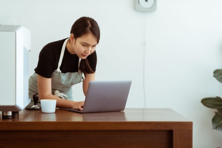 Brevo for small business — café owner checking email campaigns on a laptop