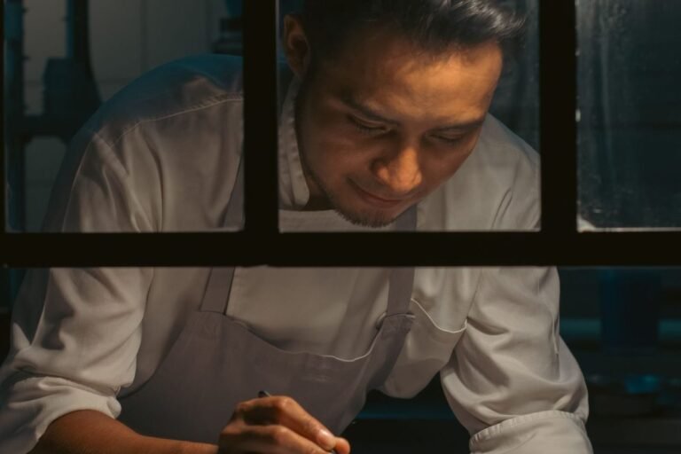 Constant Contact for restaurants — chef plating a dish in a busy restaurant kitchen